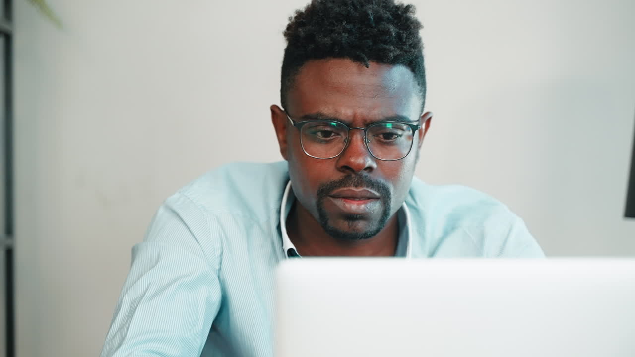 Man Concentrated on Laptop in Office