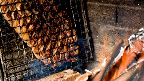 Säfte-Tropfen-Vom-Lammkarree,-Wenn-Es-Neben-Offenem-Holzfeuer-Gegrillt-Wird