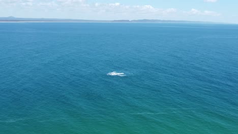 Aerial-view-of-jet-skis-playing-below-in-the-ocean