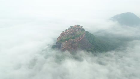 sigiriya lions rock front in sri lanka, village on top of a rocky mountain