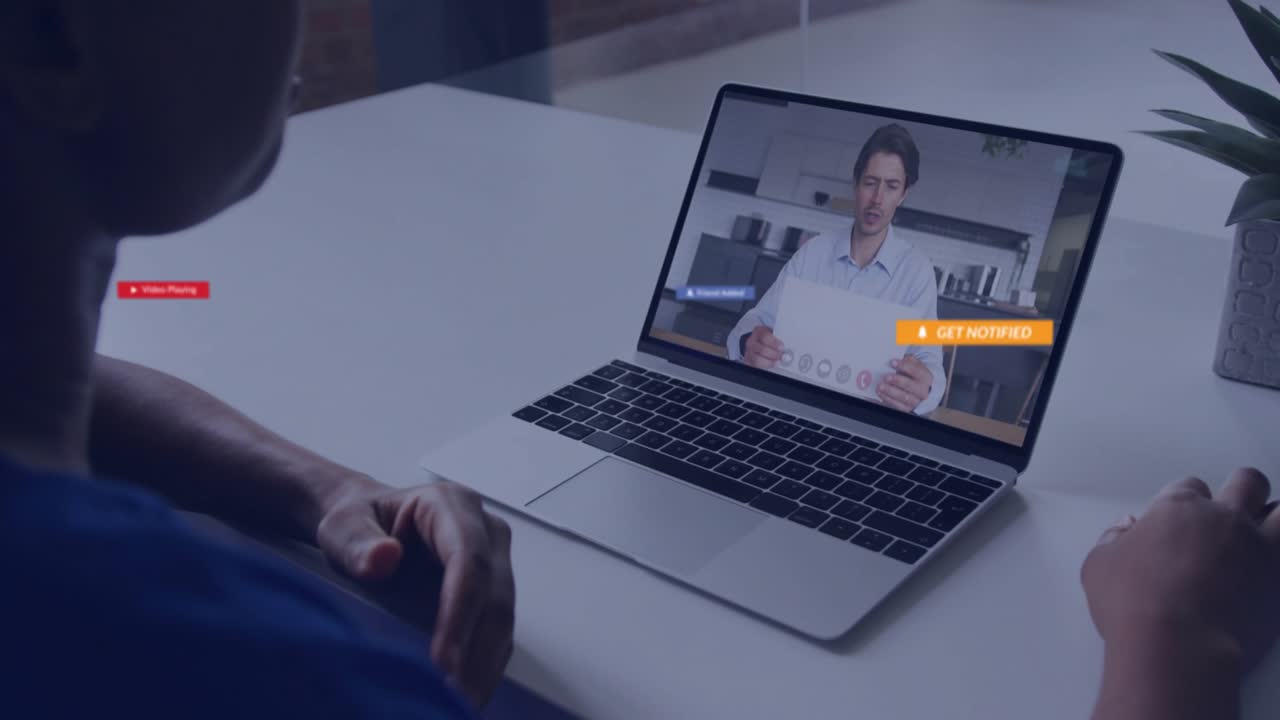 Viewer clicking play button on laptop activating red alerts, icons swirling fading in tech demo