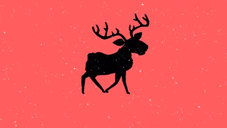 Snow-falling-over-silhouette-of-reindeer-walking-against-orange-background