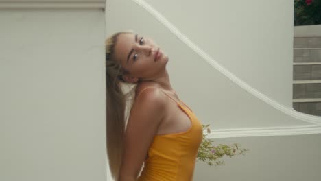 woman posing in yellow dress