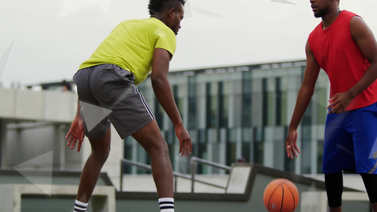 Dribbler bouncing basketball and executing crossover dribble to beat defender on rooftop court