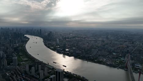 drone aerial view of buildings, cityscape and river in downtown