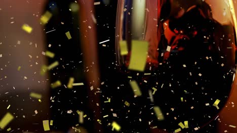 Animation-of-golden-confetti-falling-over-glass-of-red-wine