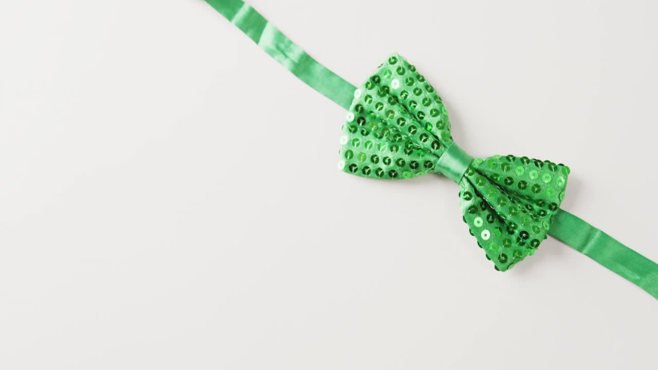 Video of st patrick's green bow tie with copy space on white background