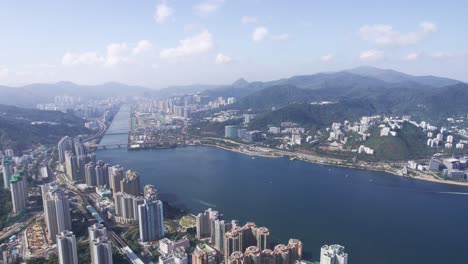 high skyscrapers at vista paradiso and big appartments in the background between the mountains of tai po kau and shing mun river on a cloudy and sunny day