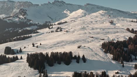 Dolly-forward-drone-shot-towards-ski-chalet-and-slope-in-the-Italian-dolomites