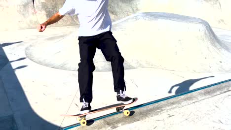 male skater make turns in ramp in wooden skatepark, wide angle view in slow motion