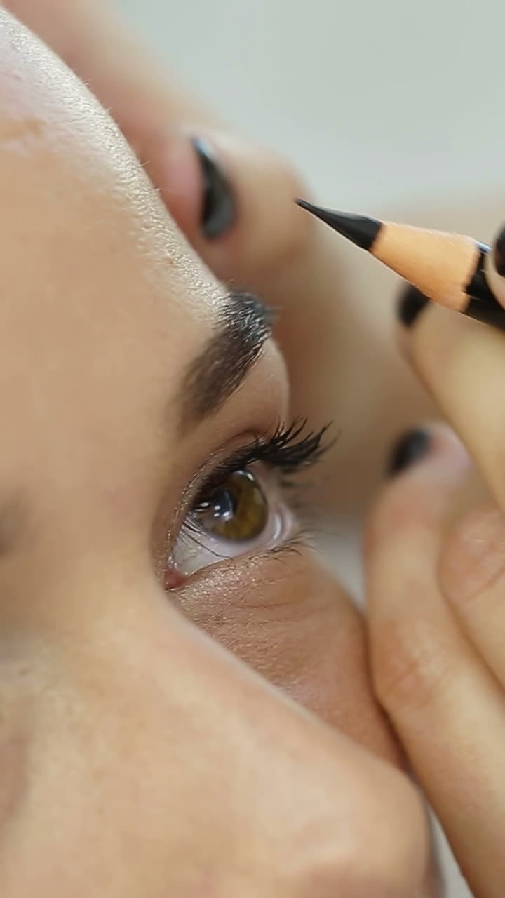 Permanent Tattooing Of Eyebrows. Cosmetologist applying permanent make up on eyebrows