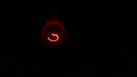 incandescent light bulb in dark room