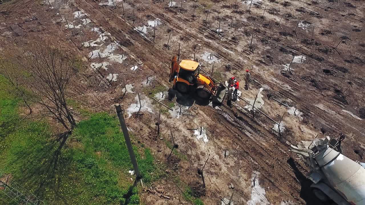 Excavator working on field. Industrial excavator during construction works
