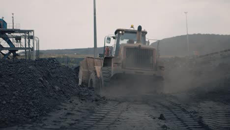 In-the-stark-backdrop-of-the-mine,-a-front-end-loader-casts-a-formidable-shadow-as-it-drives-away,-symbolizing-the-unending-pulse-of-industrial-work-and-the-raw-essence-of-resource-extraction