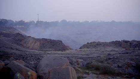 open-pit mining landscape with haze