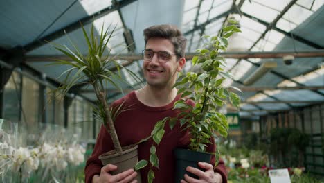 browsing botanicals: a young man's shopping adventure. a young guy with two flowers walks through a specialized flower shop