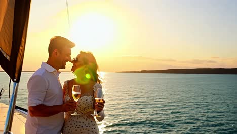 romantic couple enjoying sunset on a yacht