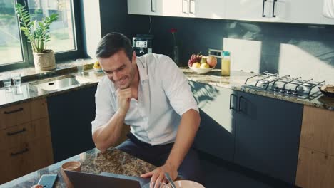 Cheerful-man-talking-at-computer.-Smiling-person-making-thumbs-up-gesture.