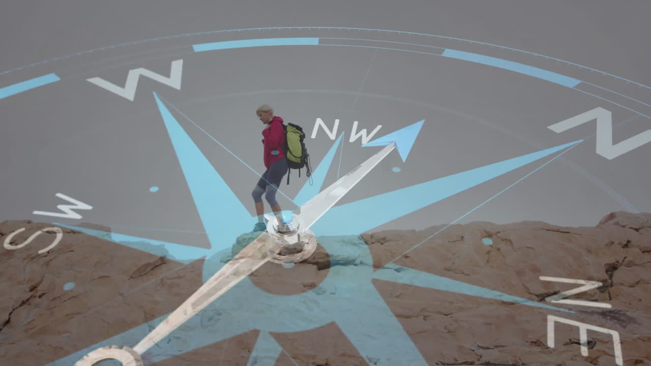 mature woman hiking with backpack using digital compass tech showing cardinal directions