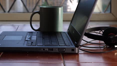 working from home laptop and headset dolly slider medium shot