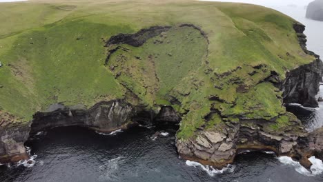 aerial zoom out of heimaey island in iceland with puffin birds and ocean