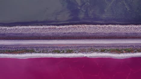 promontory point railroad showing pink and blue split of great salt lake in utah from an aerial drone perspective