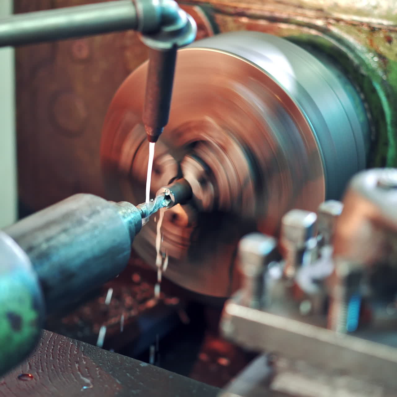 Lathe machine is turning while cutting metal on the workshop background. CNC milling machine on a factory. Metalwork