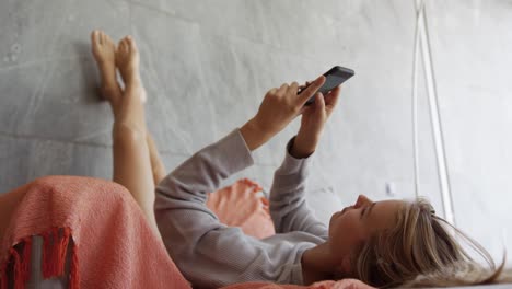 Caucasian-woman-sitting-on-couch-in-hotel-room