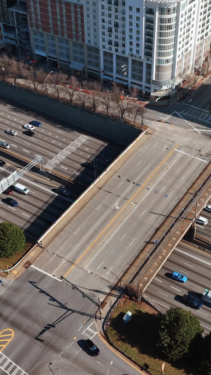Crossing street with bridge over Interstate 85 downtown in Atlanta, Georgia. Top view, aerial view. Cars on multi-lane asphalt road. Vertical