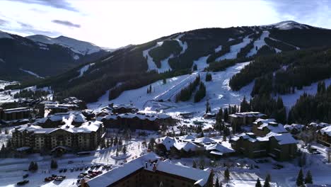 morning sunrise winter solstice copper mountain resort aerial drone center village chairlifts gondola ikon pass alterra snowboarding snow ski riding trails december halfpipe trees circle right slowly