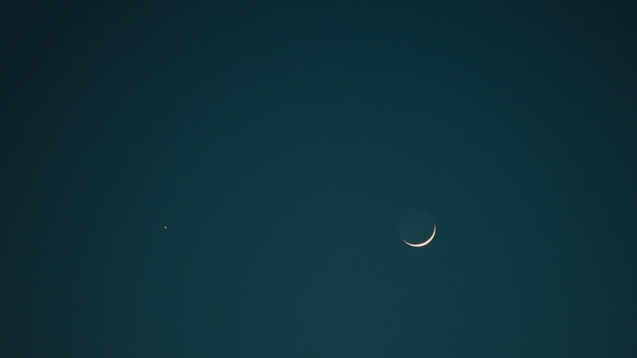 Crescent Moon and a Bright Star in the Night Sky