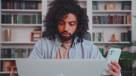Young arabian man entrepreneur working with laptop and phone in multitasking