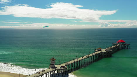 imágenes de drones de una cometa volando sobre el muelle de huntington beach