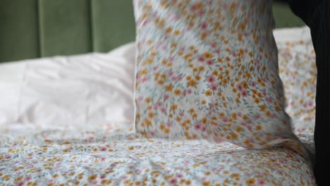 making a bed with floral bedding