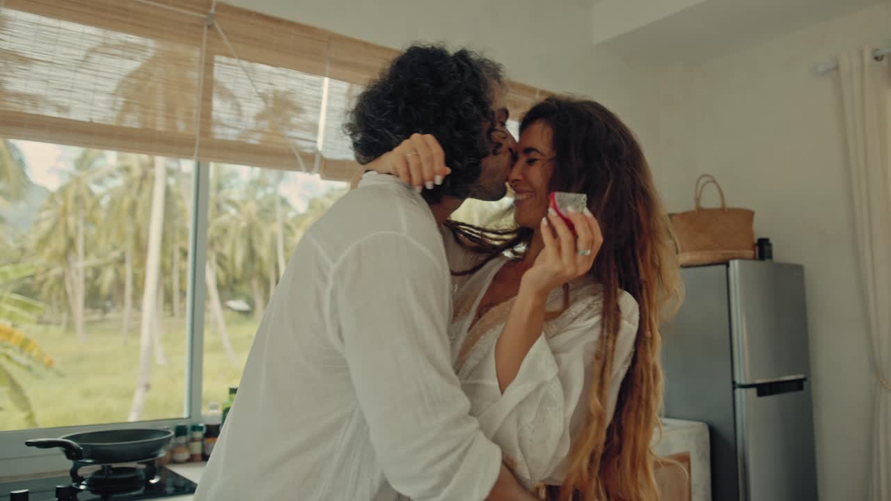 Couple Enjoying a Romantic Moment in a Tropical Kitchen
