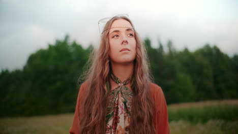 a thoughtful woman looking for inspiration against a background of a forest and meadow