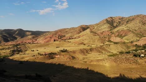 A-drone-pan-revealing-Red-Rocks-Amphitheater,-Morrison-CO