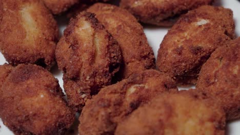 crispy spanish croquetas rotate on white background, closeup from above