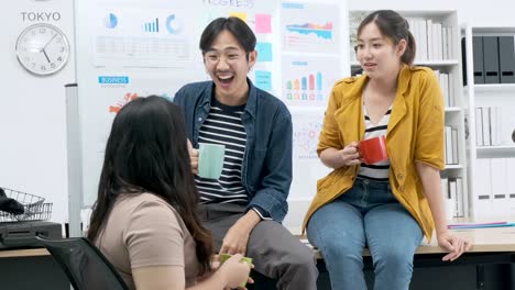 4k uhd slow motion of group of asian and caucasian young creative happy enjoy laugh smile and great success emotion teamwork people business startup entrepreneur casual brainstorm business meeting office background