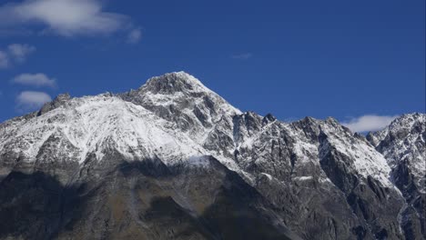 blue sky white clouds over snow mountains. puffy fluffy white clouds. cumulus cloud scape timelapse. winter blue sky time lapse. dramatic majestic amazing blue sky. soft white clouds form. clouds time lapse background