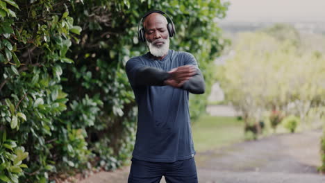 black man, senior stretching with headphones