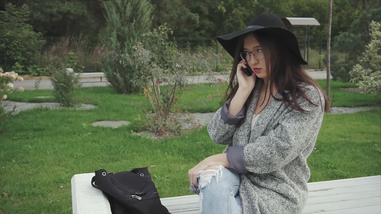 Young Woman on a Phone Call in a Park
