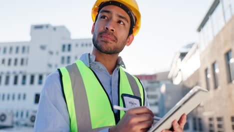 construction worker using tablet on a building site