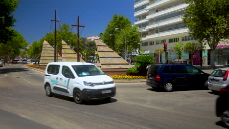 busy city street scene with unique fountain sculpture