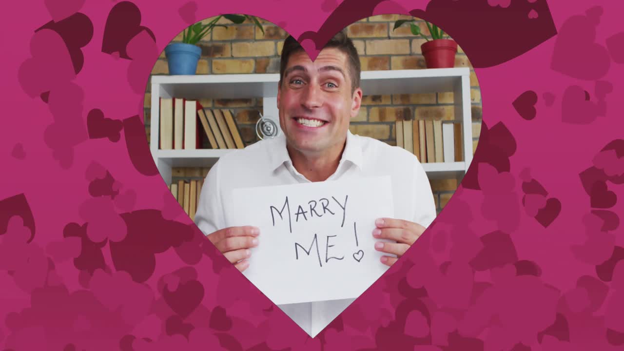 비디오 통화로 청혼하는 백인 남성 위에 분홍색 심장이 있는 심장 모양의 프레임의 애니메이션