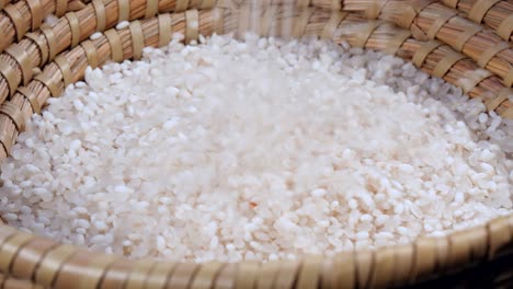 falling rice seed on bamboo container