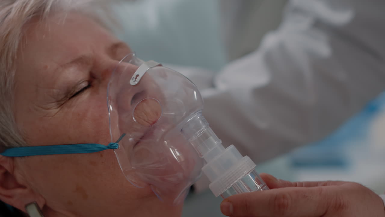 Close up of doctor applying oxygen mask on ill patient
