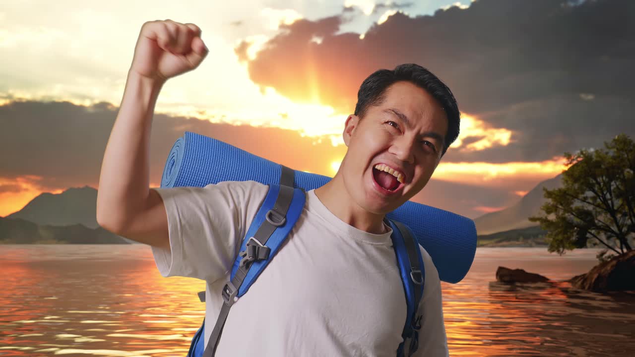 Close Up Of Asian Male Hiker With Mountaineering Backpack Screaming Goal Celebrating The Success At A Lake