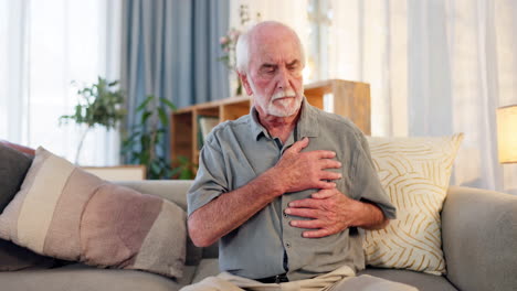 senior man experiencing chest pain at home