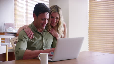 couple, laptop and browsing online to book